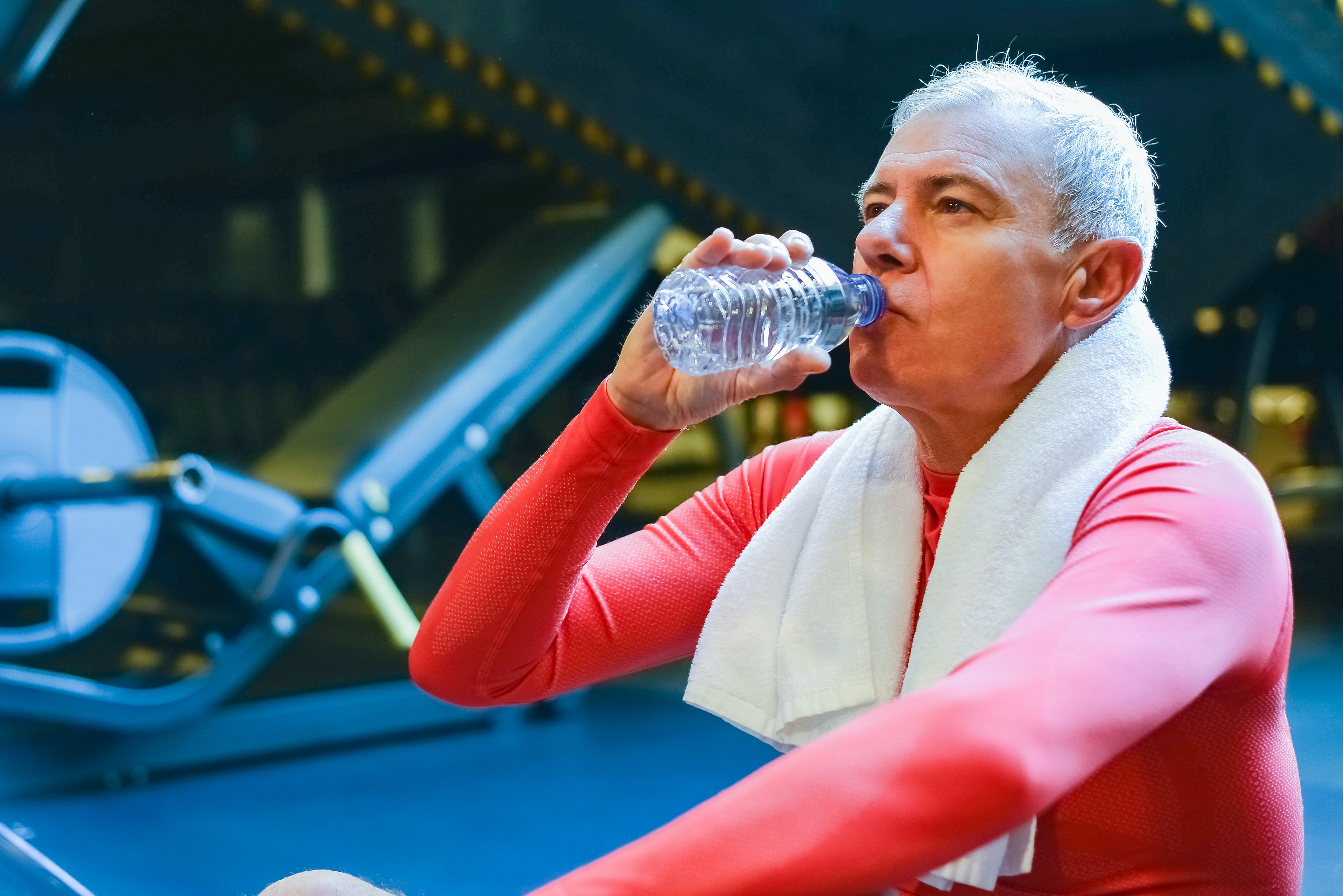 older man exercising and drinking water